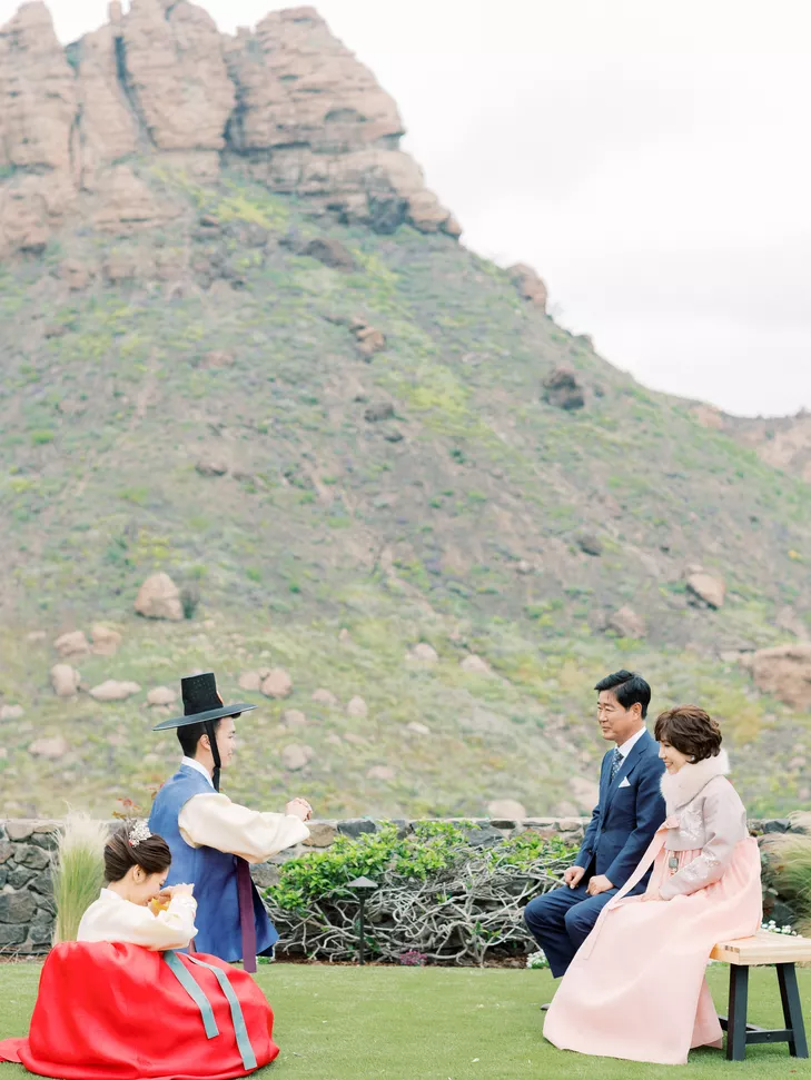 Couple bowing during Korean wedding ceremony