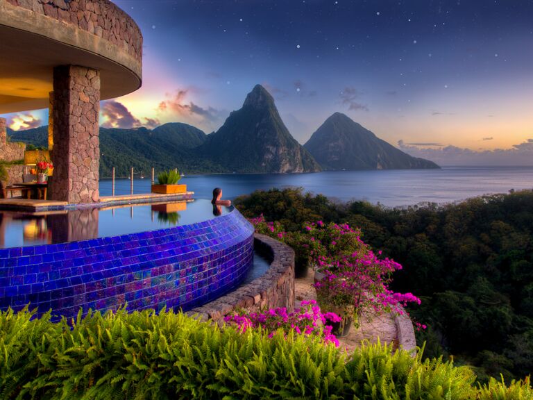 Outdoor infinity pool overlooking mountains and water at Jade Mountain all-inclusive resort in St. Lucia