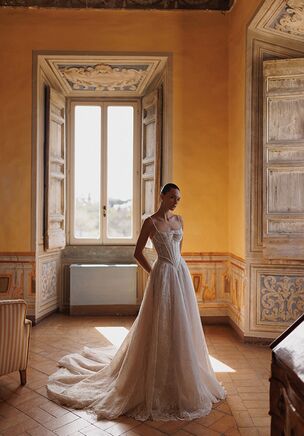 Timeless classics: straight neckline strapped corset with pointed bottom and flowing layered skirt. The dress features handcrafted floral embroidery.