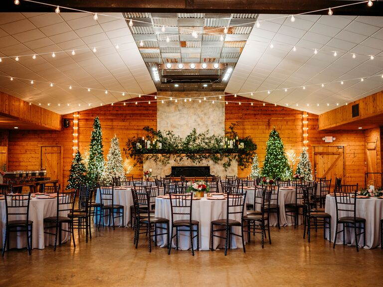 Rustic reception space with wooden walls and hanging bistro lights