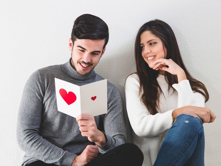 couple smiling reading funny valentine's day card message