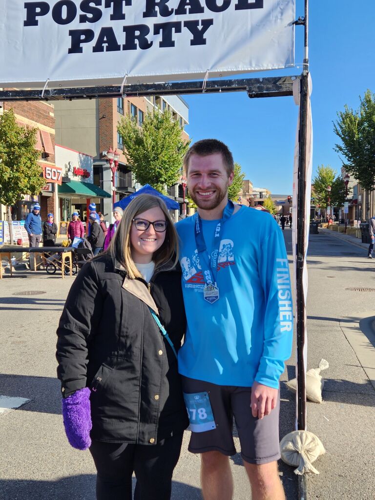 Cheering on Brett - Brett is very passionate about running. Brett has run 3 marathons and 8 half marathons. Kaylee loves cheering him on from the sidelines!