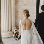 Bride with open-back wedding dress and updo hairstyle