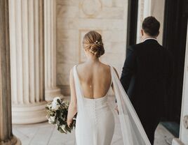 Bride with open-back wedding dress and updo hairstyle