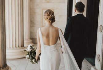Bride with open-back wedding dress and updo hairstyle