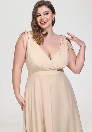 This elegant bridesmaid dress features a beautiful V-neckline, with delicate tie straps at the shoulders for an added feminine touch. The wrap-style bodice seamlessly transitions into a full, flowing skirt with a side slit that allows for graceful movement. On the back, the dress showcases a stylish deep V design, highlighting a clean and simple zipper closure for a secure fit. Made from soft, lightweight chiffon, it offers a luxurious feel while allowing for comfortable wear throughout the event. The fabric's fluid drape enhances the romantic aesthetic, making it a perfect choice for a wedding celebration.