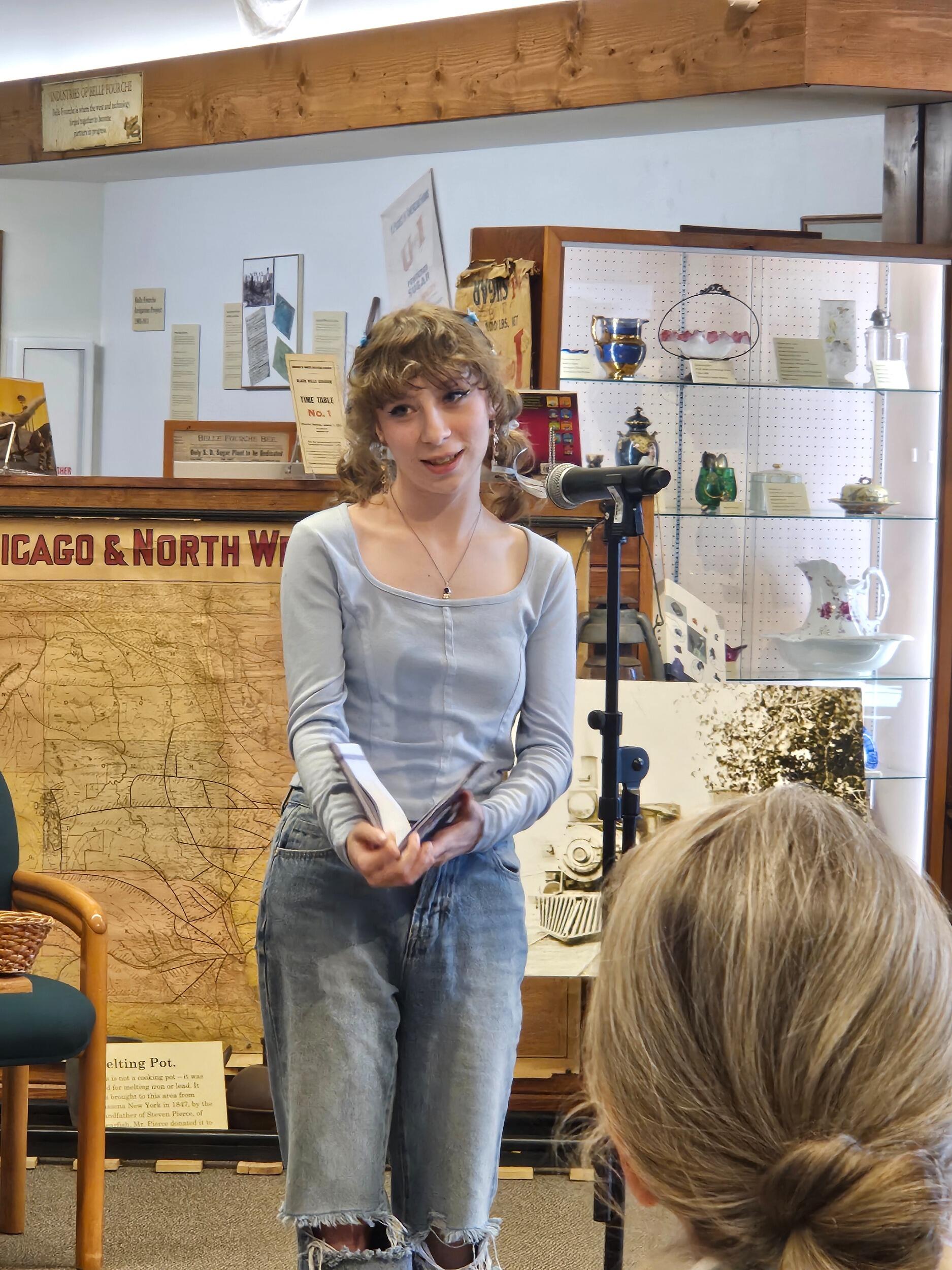 Raye reads poetry at an open mic with the South Dakota Poet Laureate