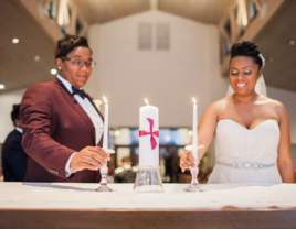 Couple lighting the ceremonial unity candle