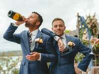 Grooms drinking champagne on wedding day