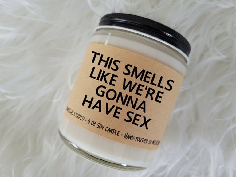 Soy candle with label reading 'This smells like we're gonna have sex'