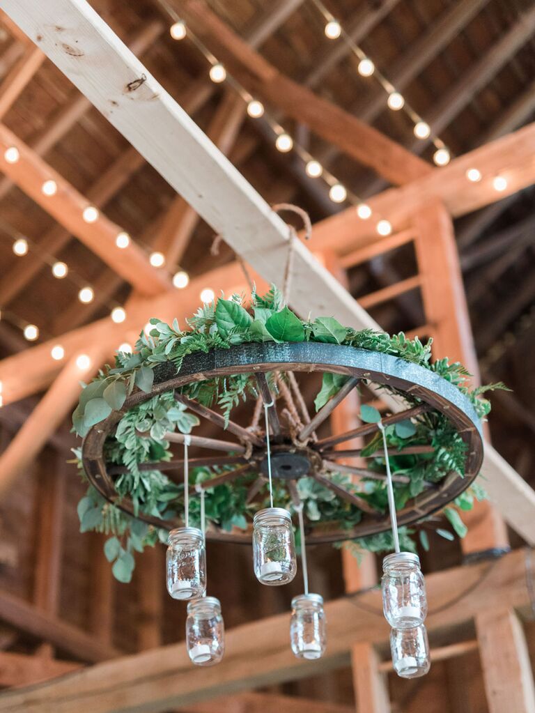 Mason jars hanging from ceiling of rustic barn wedding venue