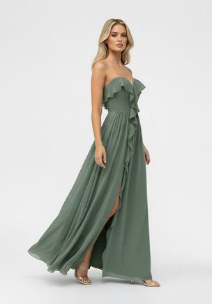 Make a statement with this playful yet elegant bridesmaid dress, designed to feel as good as it looks. Crafted from flowing Poly Chiffon with a comfortable Stretch Lining, this gown features a strapless sweetheart neckline that beautifully frames the shoulders. Soft ruffle detailing cascades down the front, adding movement and a touch of romance, while the front slit brings a flirty, modern edge. Finished with a graceful A-line silhouette, this dress is perfect for bridesmaids who want effortless style with a little extra wow.
