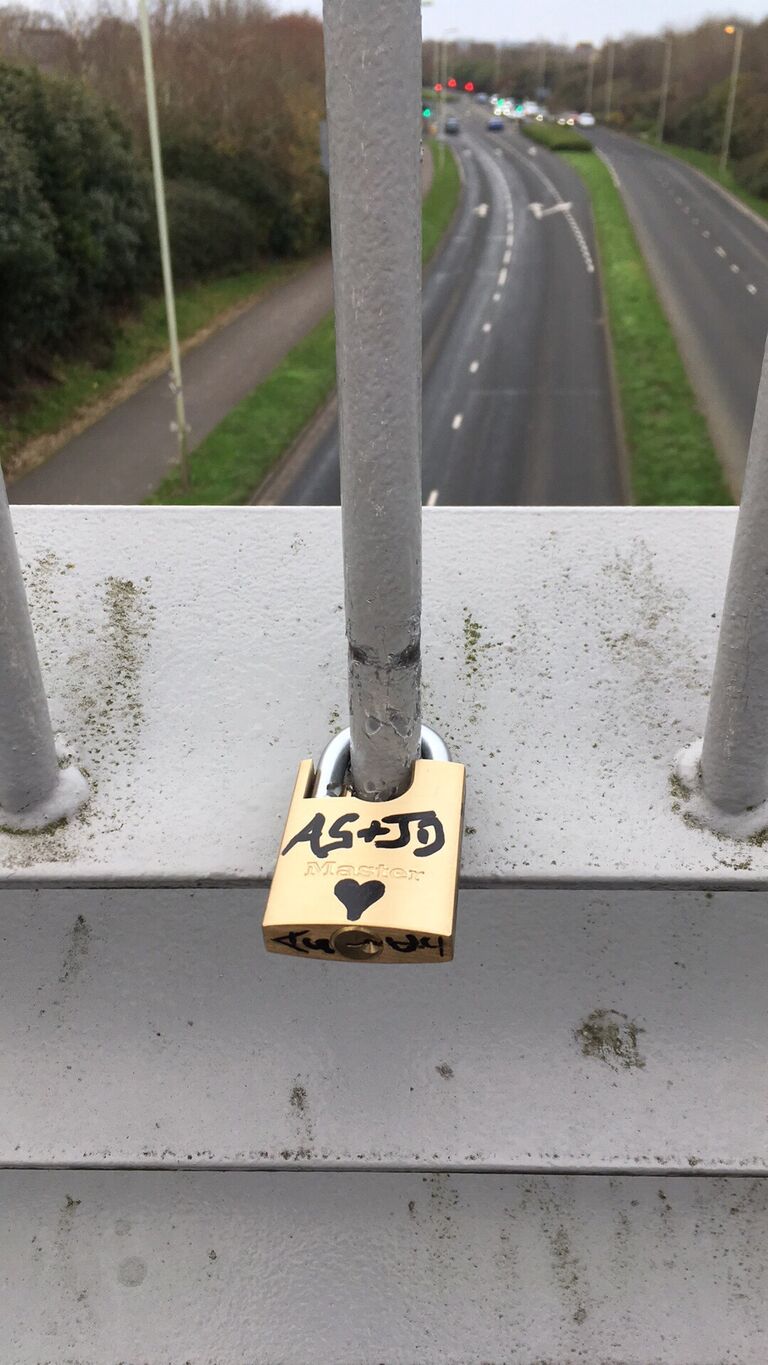 Justin placed a love lock on a bridge near his home, facing west (towards AG, in the US).