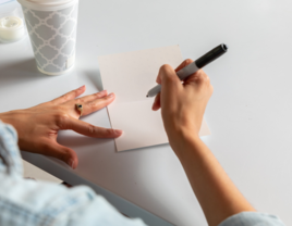 Woman writing bible verses on cards for bridal shower