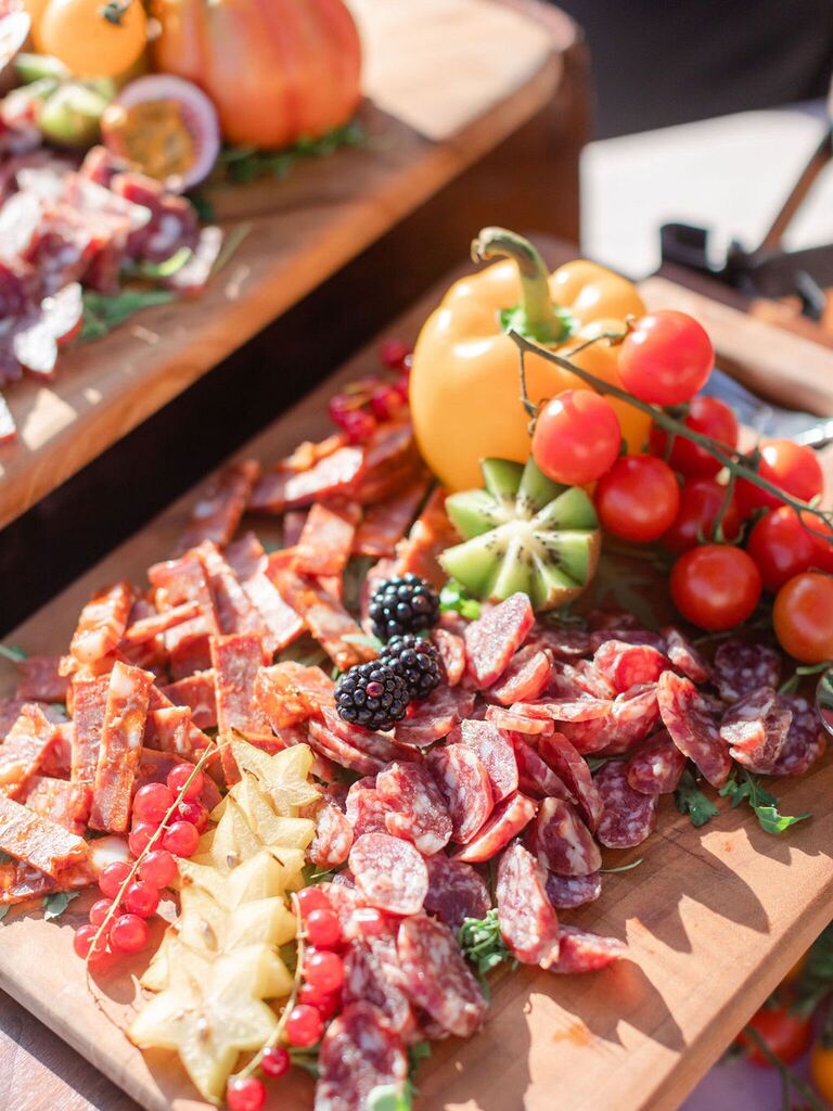 Star-shaped fruit and cheese on grazing table at wedding