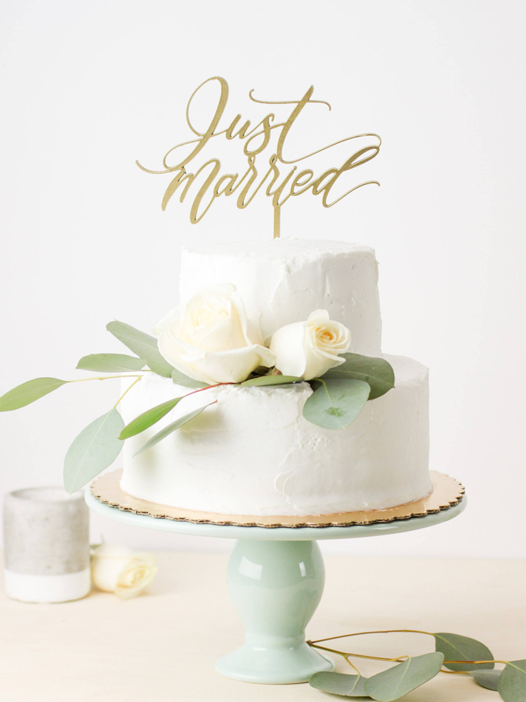 'Just Married' cake topper in gold calligraphy