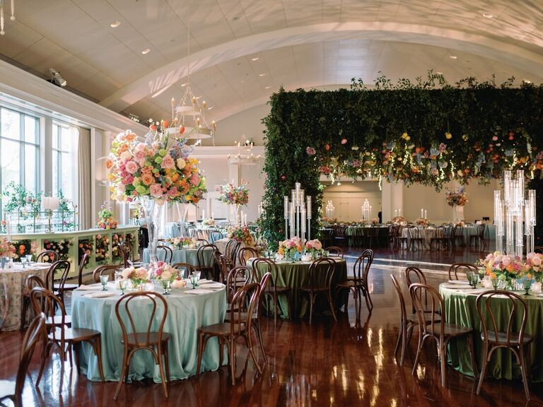 Colorful indoor reception space with florals and foliage