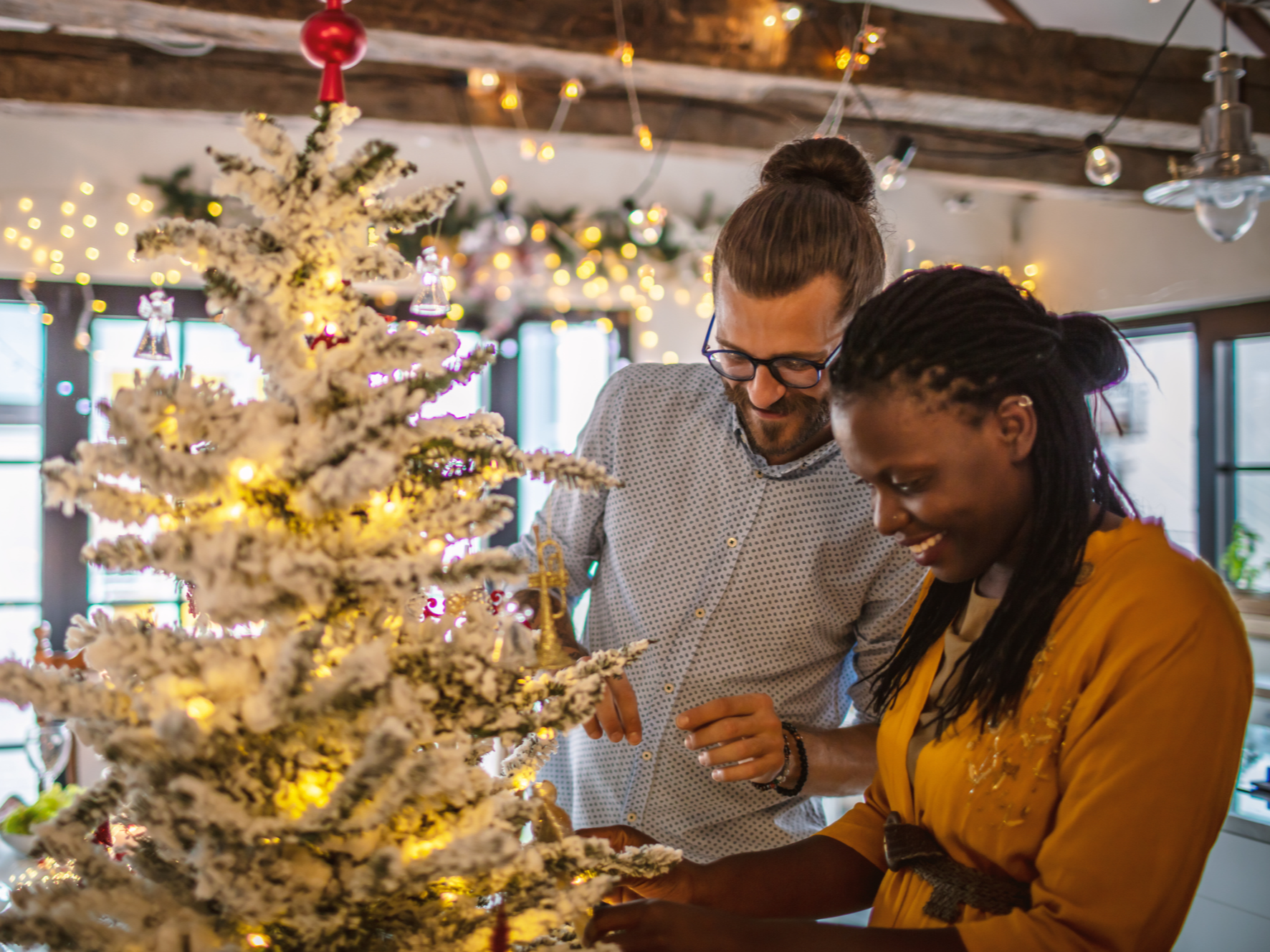 Couple decorating Christmas Tree