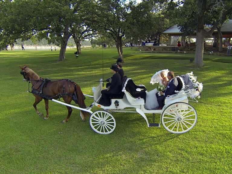 Couple in a horse-drawn carriage to their venue