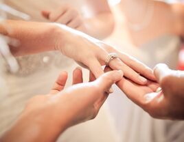 Wedding guests admiring bride's engagement ring