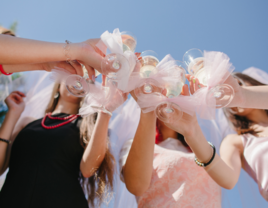 Bride and guests clinking glasses at bridal shower