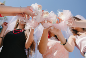 Bride and guests clinking glasses at bridal shower
