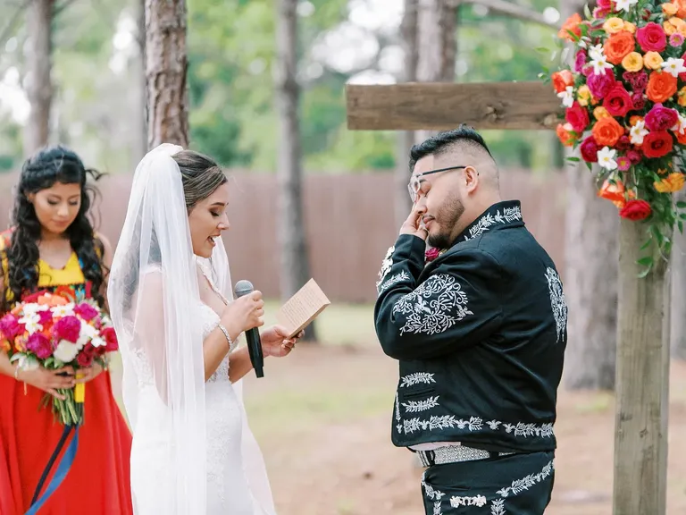 Groom crying while exchanging vows with bride