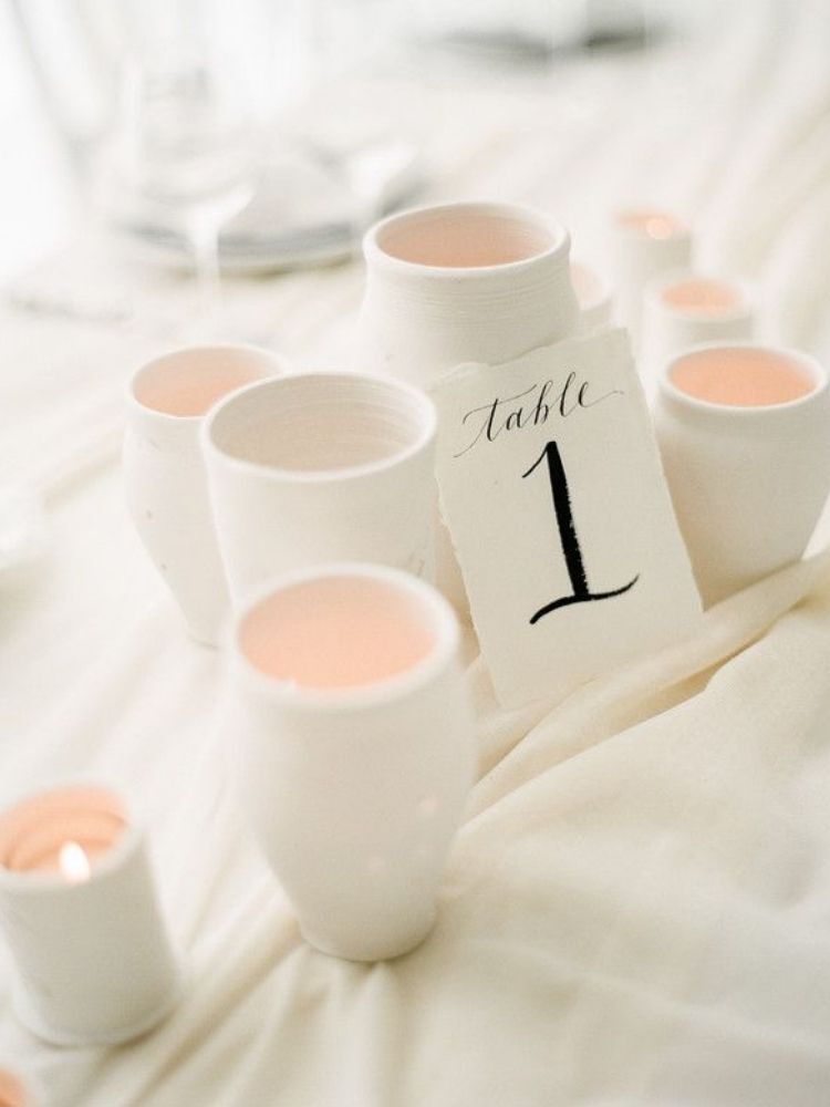 white candle holders and white table number