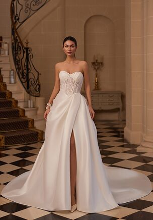 The Moonlight Couture H1656 wedding dress blends classic romance with modern edge, featuring a Chantilly lace strapless bodice with a sweetheart neckline, illusion back, and sculpting basque waist. Finished with a matte stretch Mikado wrap skirt with gathered draping and a flowing chapel train, this ivory A-line gown offers effortless structure, texture, and movement.