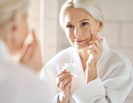 Mature woman applying face cream