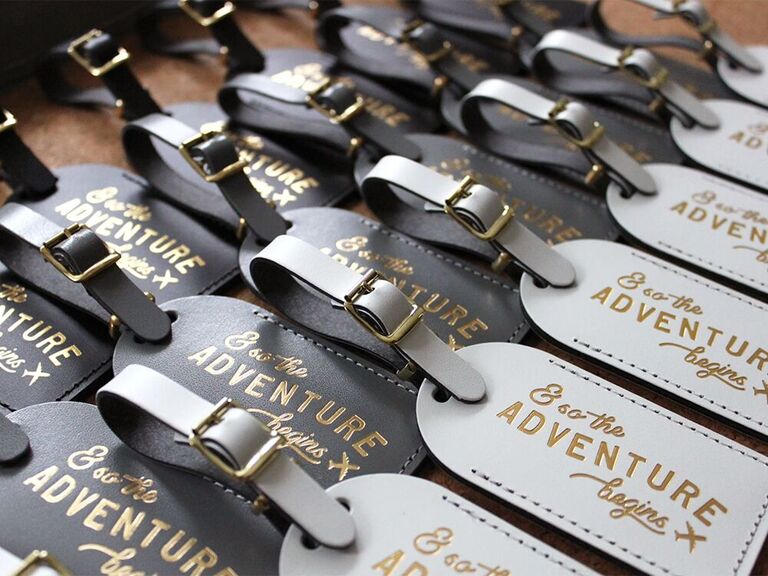 Travel-themed bridal shower invitations in the shape of luggage tags