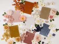 collection of velvet vow books for wedding in various colors with matching flowers