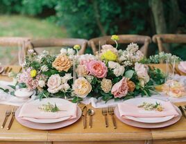 romantic garden style wedding centerpiece with blush, pink yellow roses and greenery