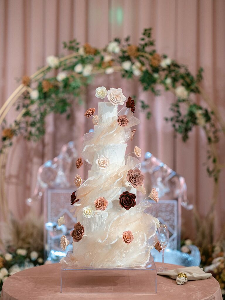 luxury seven tier wedding cake decorated with sugar flowers and clear sugar ribbons inspired by icicles