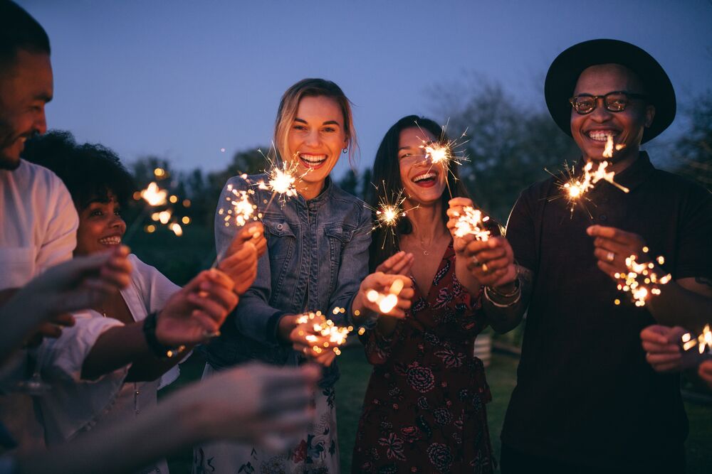 group of people with sparklers