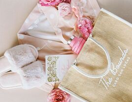 Bridesmaid gift bag with slippers, pajamas, a water bottle and candy