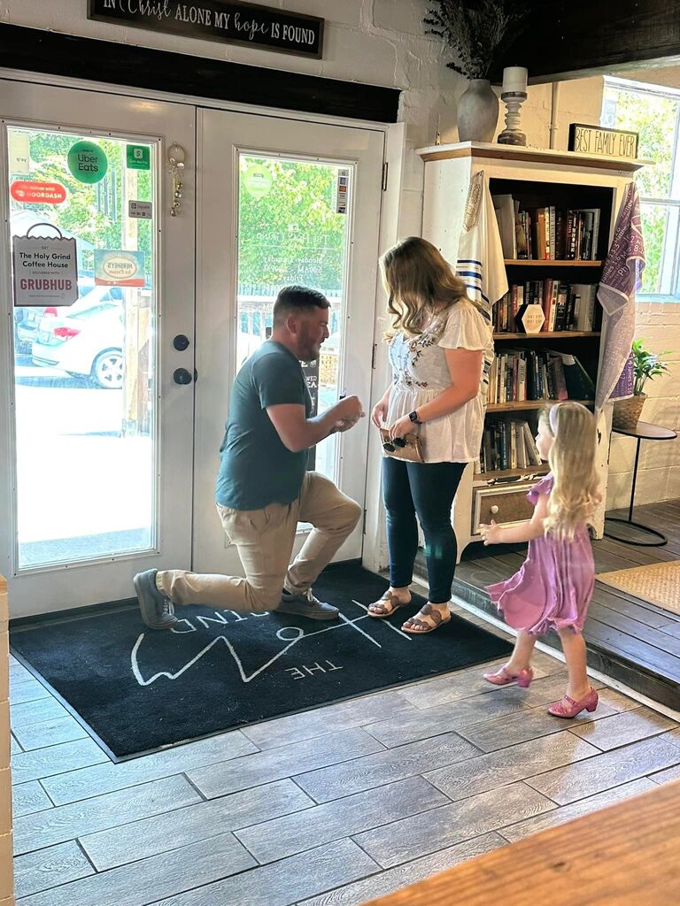 The Proposal ... Josh had the perfect proposal all planned out, and Hannah had no idea what was coming. When they woke up, Jameson was excited to go to the flea market with Hannah's parents. Hannah and Josh were excited to have a morning to themselves. Hannah had wanted to take Josh to Holy Grind, a local coffee shop where she had prayed for her future husband for many years, but she woke up with a sore throat. She was still determined to take Josh there because it was so special to her, but he kept insisting they could do it another time when she was feeling better. So instead he went to the store and got her all kinds of medicines to get feeling better quickly. They had plans to meet her parents and Jameson for lunch, then they were going ice skating afterwards since they had promised to take Jameson. They were on their way to meet Hannah's parents when Josh said they'd stop and grab a coffee so she would have some energy. Hannah told him no, that it was the opposite direction and they didn't want to be late to meet her parents. Josh insisted he wanted to take her because he knew it was important to her. Hannah pushed back again because she didn't want to be late, but accepted it because she wasn't one to ever turn down coffee. When they walked in Hannah was surprised to find her family and friends ... including one that was supposed to be in the mountains that weekend. She turned and Josh had dropped to one knee. Josh was full of nerves and about to have a heart attack, but he got out the words "Will you marry me?" Hannah immediately said "YES, of course" and everyone was cheering. It was the most thoughtful and special proposal, in the perfect place. They were able to celebrate the next step in their relationship in a place where so many prayers had been prayed before they ever met. Jameson was excited for his dad and Hannah, but still wanted to make sure they were going ice skating that day. They celebrated their engagement with their families at lunch, then stayed true to their promise and went ice skating together with Jameson. 