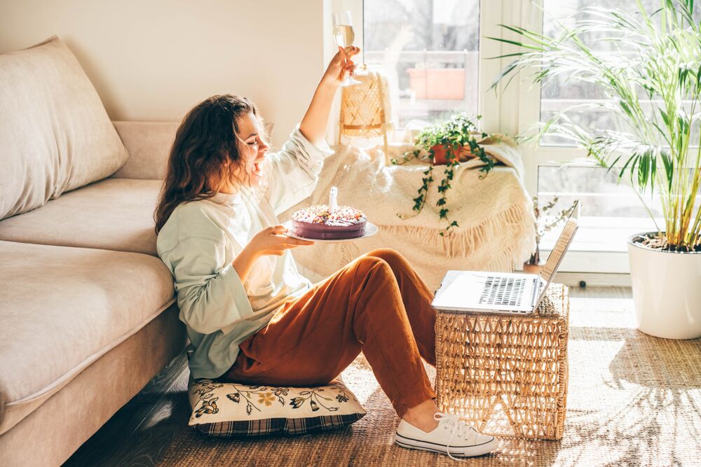 adult celebrating a virtual birthday party