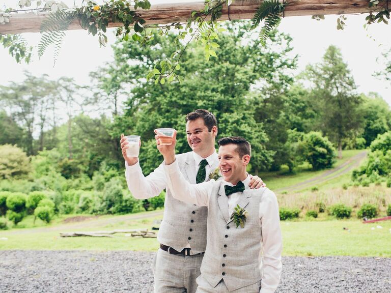 Grooms toasting after wedding speeches.