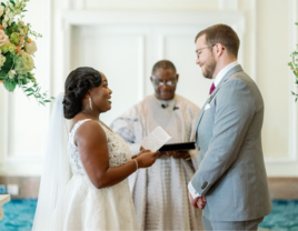 Couple on wedding day in front of officiant