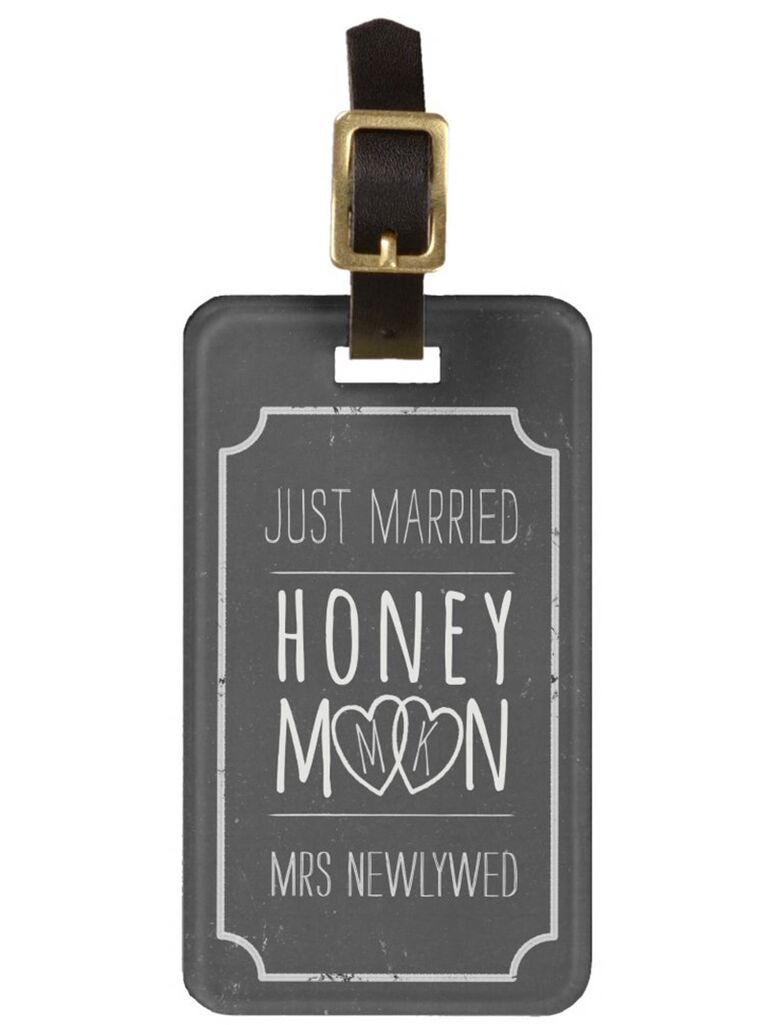 Chalkboard tag with 'Just married' 'Honeymoon' and 'Mrs. Newlywed' in sans serif white type