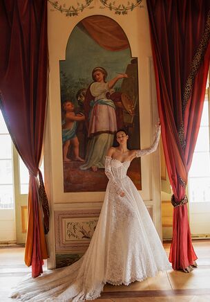 An elegant A-line silhouette gown made from luxurious corded lace with a vintage-inspired matte finish. The sweetheart neckline adds a touch of romantic charm, beautifully complementing the overall classic look. The dress features removable long sleeves that can be easily attached or detached with discreet zippers, allowing for two different looks in one. The corset is lace-up, offering a perfect fit and emphasizing the waistline. A graceful chapel-length train completes the look, adding a refined and timeless touch. Ideal for brides who appreciate classic elegance with a vintage soul.