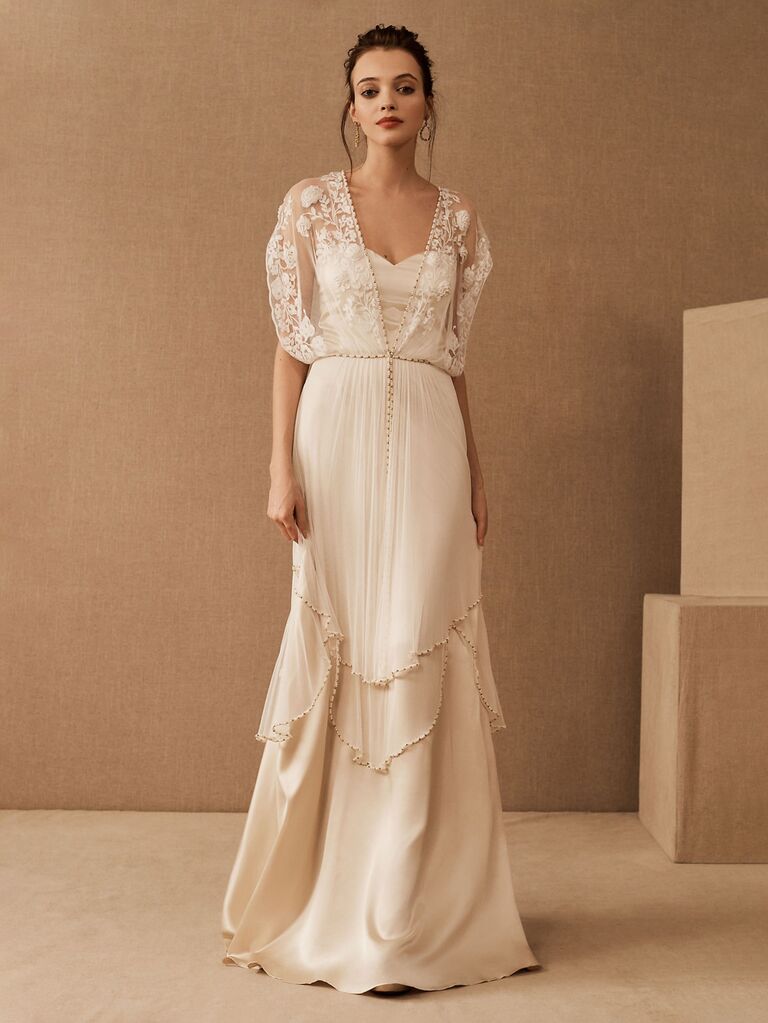 bhldn off white sheath wedding dress with sweetheart neckline flowy tiered skirt with beading and short sleeve lace sash with beading
