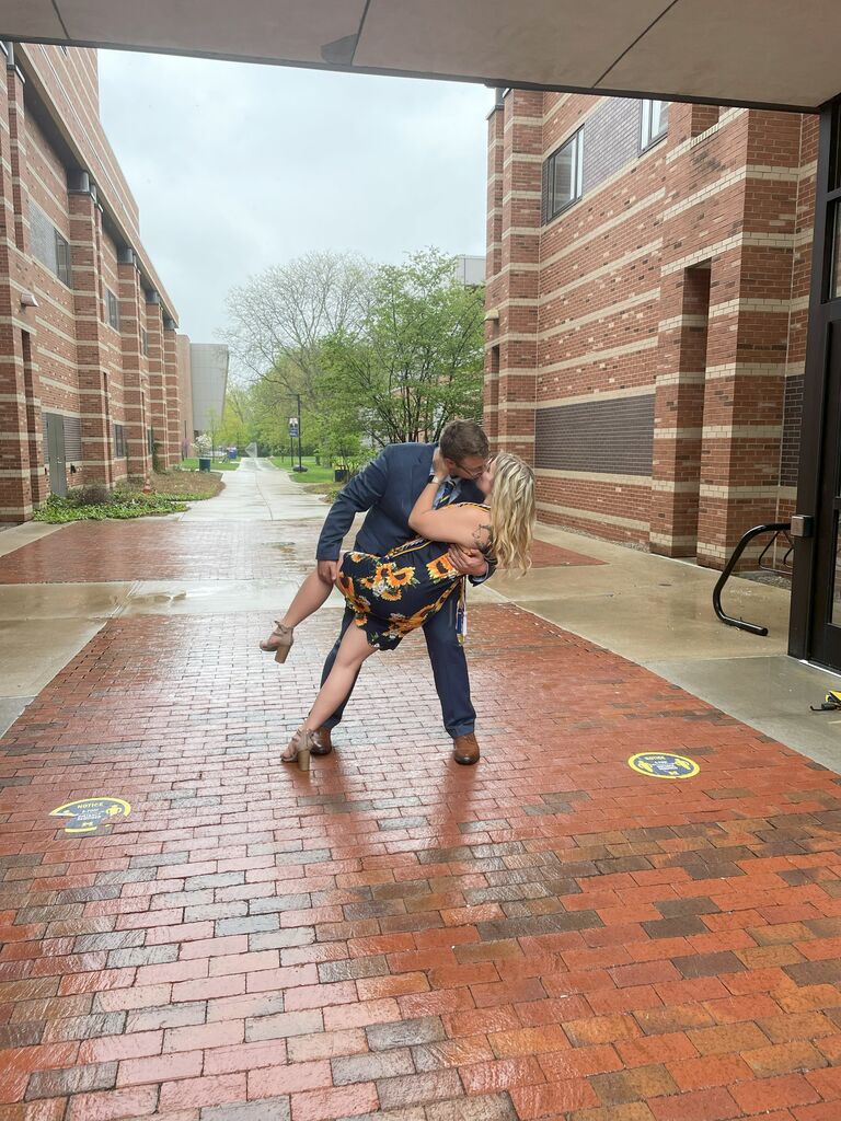 The day Alexis graduated from college.  They insisted on a kiss under this arch on campus to fulfill a tradition their orientation leader boss wanted to create to ensure everlasting love between the couple.