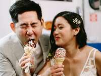 The newlyweds enjoy cones of soft-serve ice cream. 