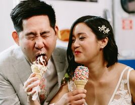 The newlyweds enjoy cones of soft-serve ice cream. 