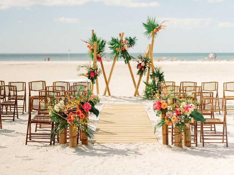Beachside wedding ceremony with stunning florals. 