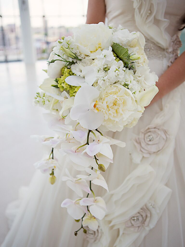 Cascading white bouquet with orchids, peonies and sweet pea