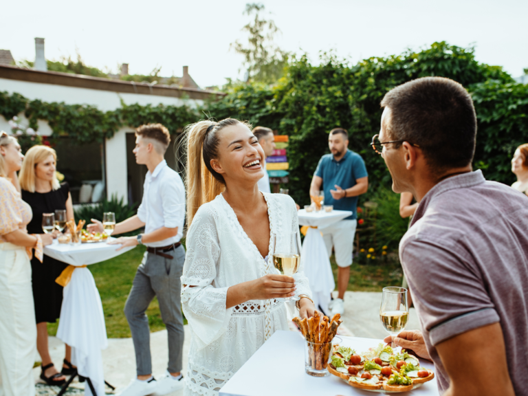 Guests and couple laughing together at engagement party