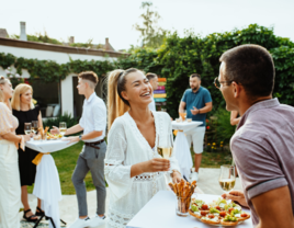 Guests and couple laughing together at engagement party